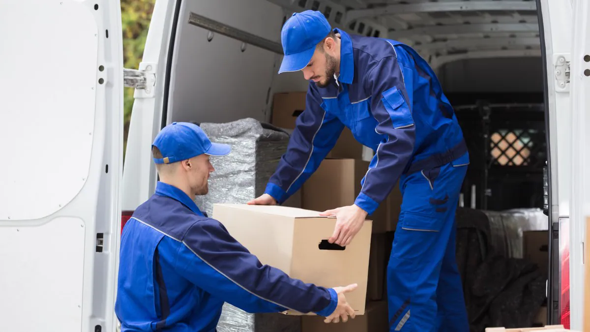 Déménageurs chargeant un carton dans leur camion