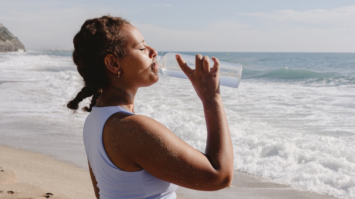 Femme buvant de l’eau en plein air, bien-être
